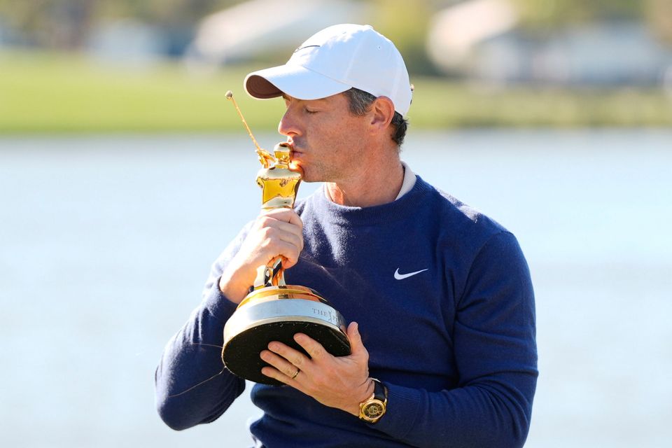 Rory McIlroy kisses the trophy after winning The Players Championship following a play-off against JJ Spaun yesterday